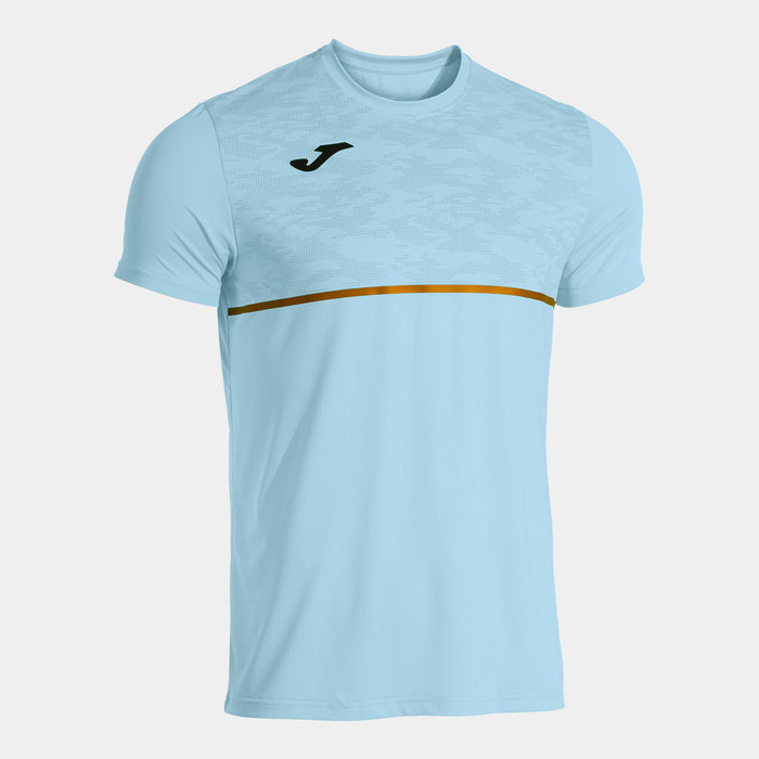 A short-sleeved sky blue t-shirt with a gold stripe across the chest and the Joma logo on the chest.