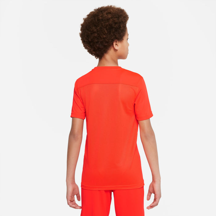 Back of boy wearing Nike Dri-fit Park VII Shirt Short Sleeve Shirt in Bright Crimson