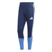 Navy and blue Adidas pants with three white stripes on a white background