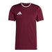Maroon t-shirt with white collar and Adidas logo on a white background
